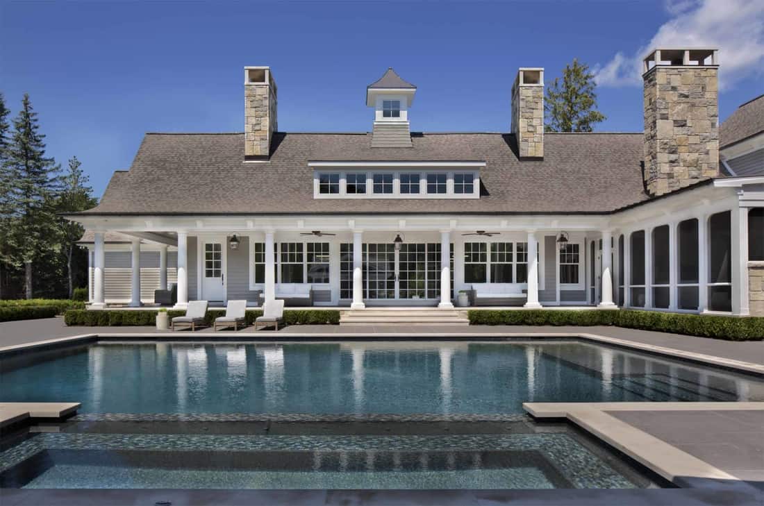 The home's back porch and lanai surround a sparkling pool.