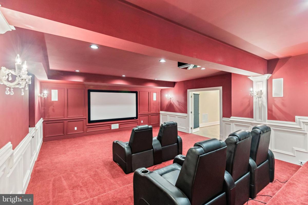 The house features a theater for relaxation lit with luxurious wall lights.