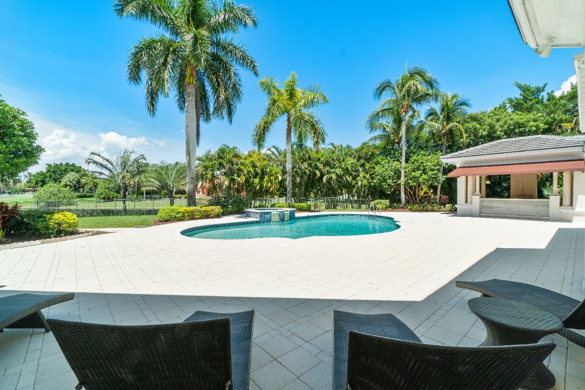 The sun-lounger in front of the pool has a view of the surrounding.