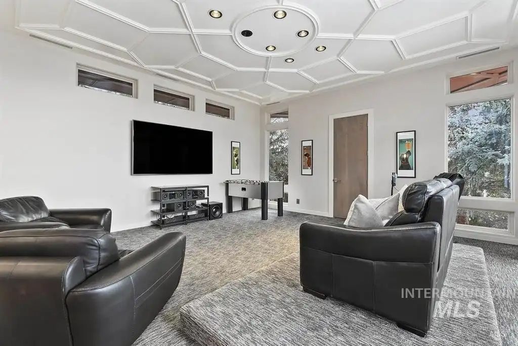 The entertainment room features a leather sofa and indoor games.