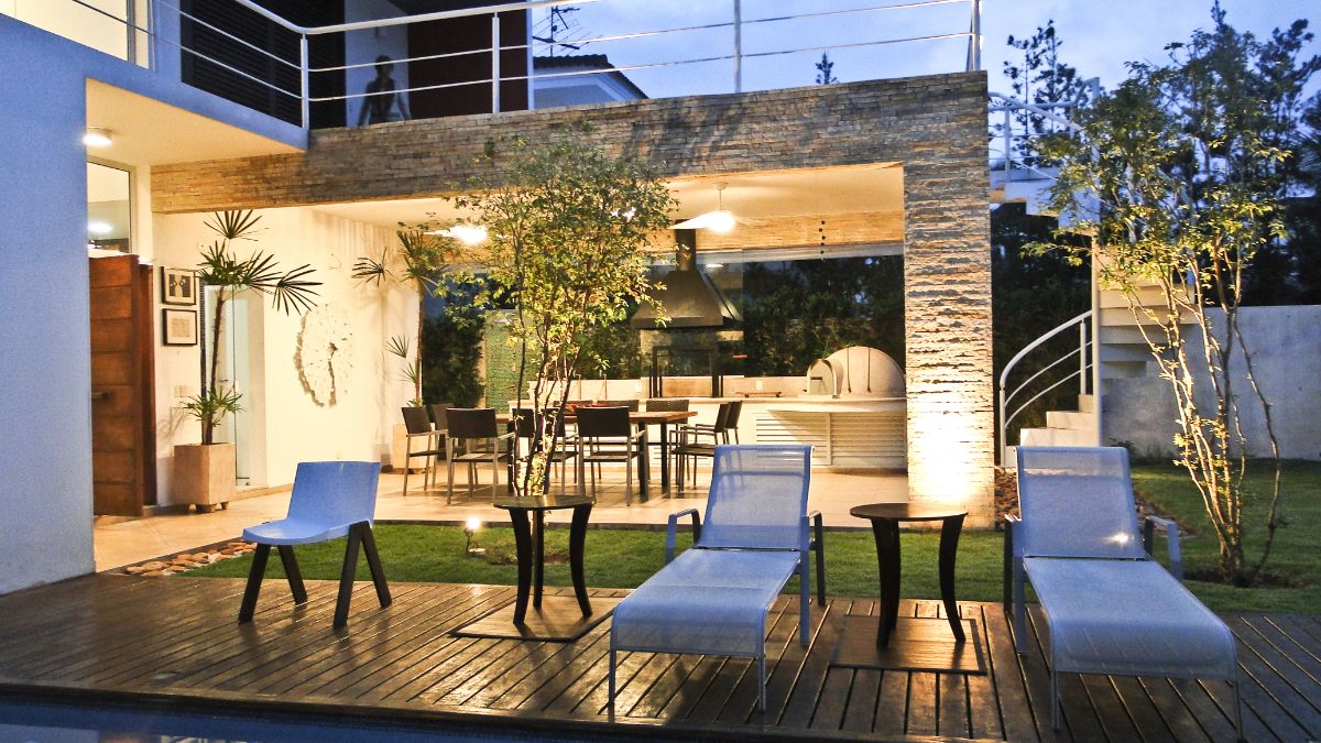 During the night, the backyard is lit with accent lighting giving the house a dramatic effect.