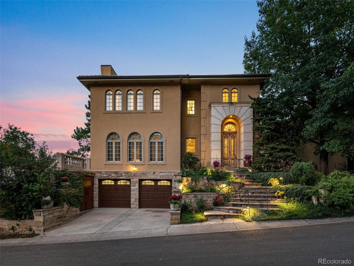 The exterior of the house has a concrete finish, and the landscape blends well with the stone way giving off a classic look.