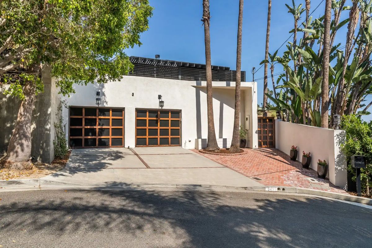 The exterior of the house has a concrete finish and brick flooring, giving off a rough texture.