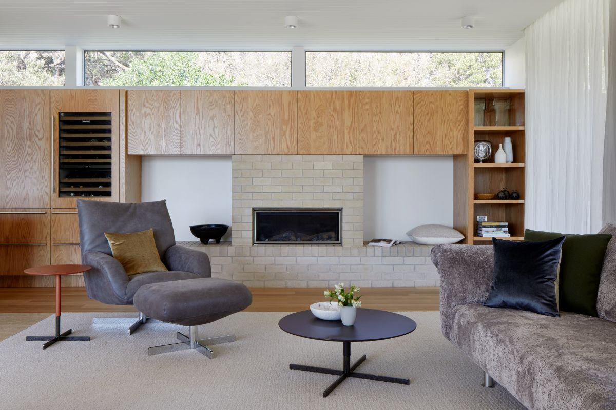 The modernist living room with sofa and an electric fireplace.