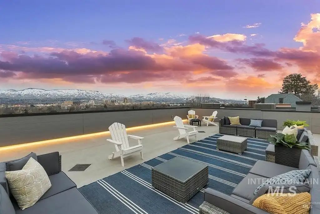 The top floor features accent lighting and a patio that showcases the view of the mountains.