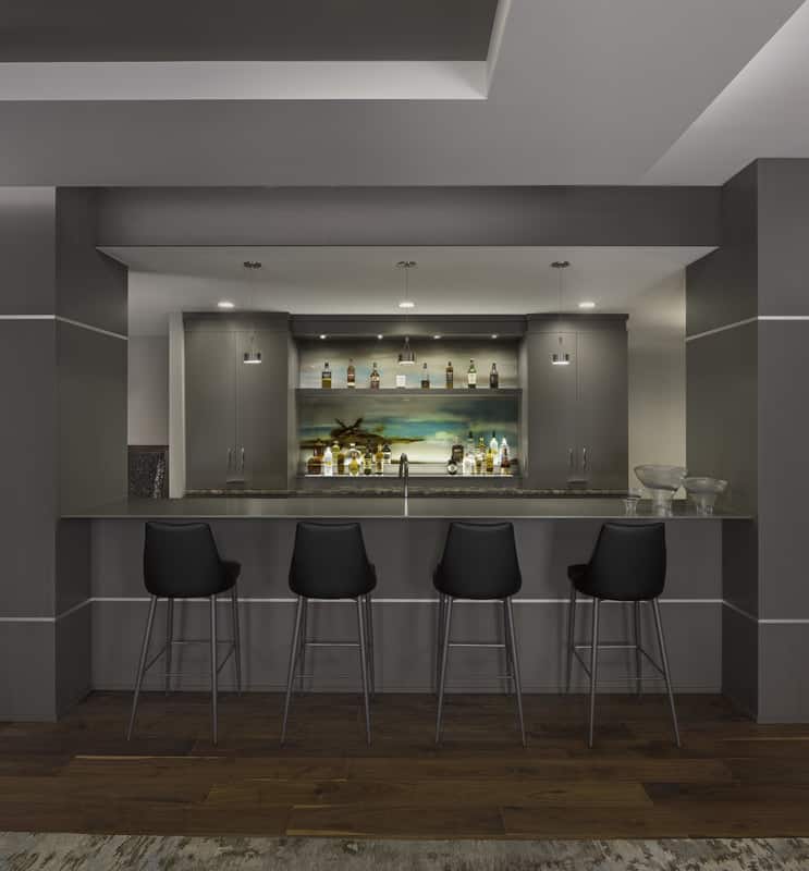 A fun wet bar enhances the basement's entertainment.