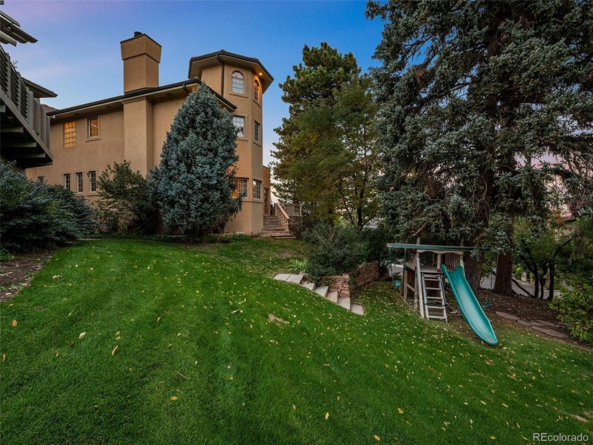 The house features a playground for kids and a lawn leading to the pool.