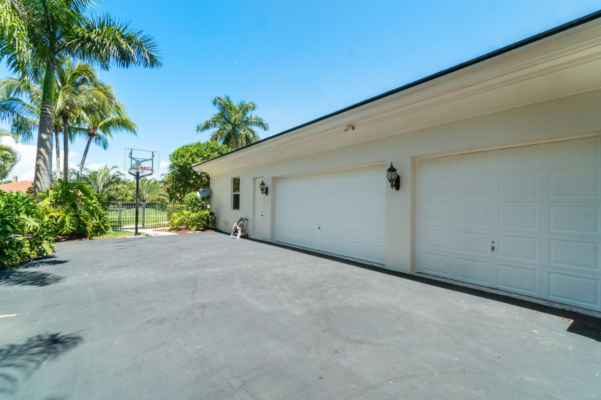 The house features a garage to cater multiple cars, and the driving space is also used as a basketball court.