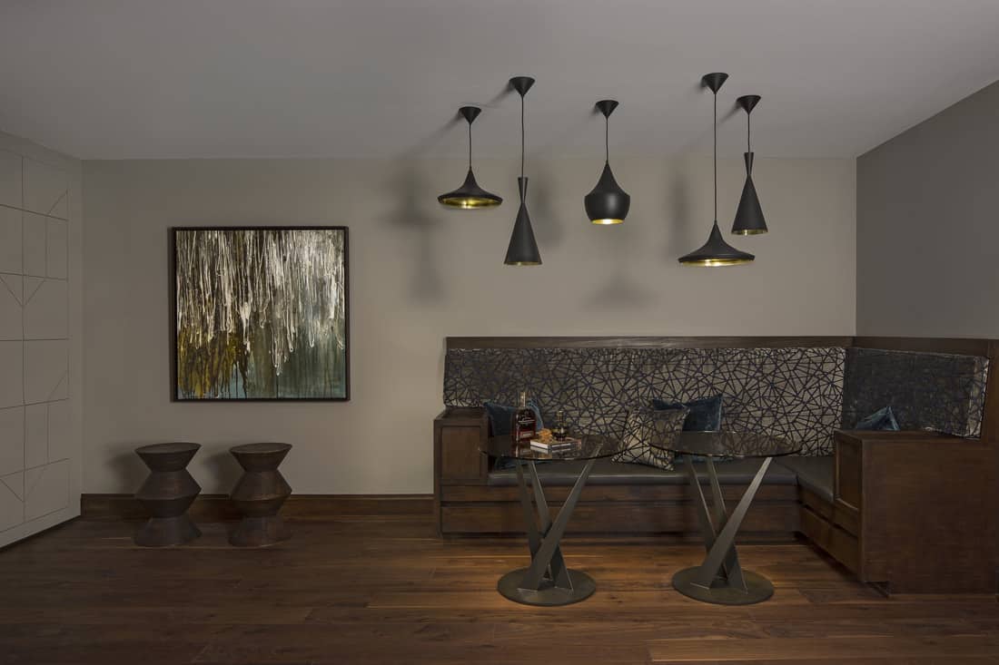 Black dome pendants in various styles illuminate this corner's seating area.