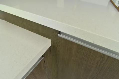 This photograph provides a close-up view of the material used to construct the kitchen cabinetry.