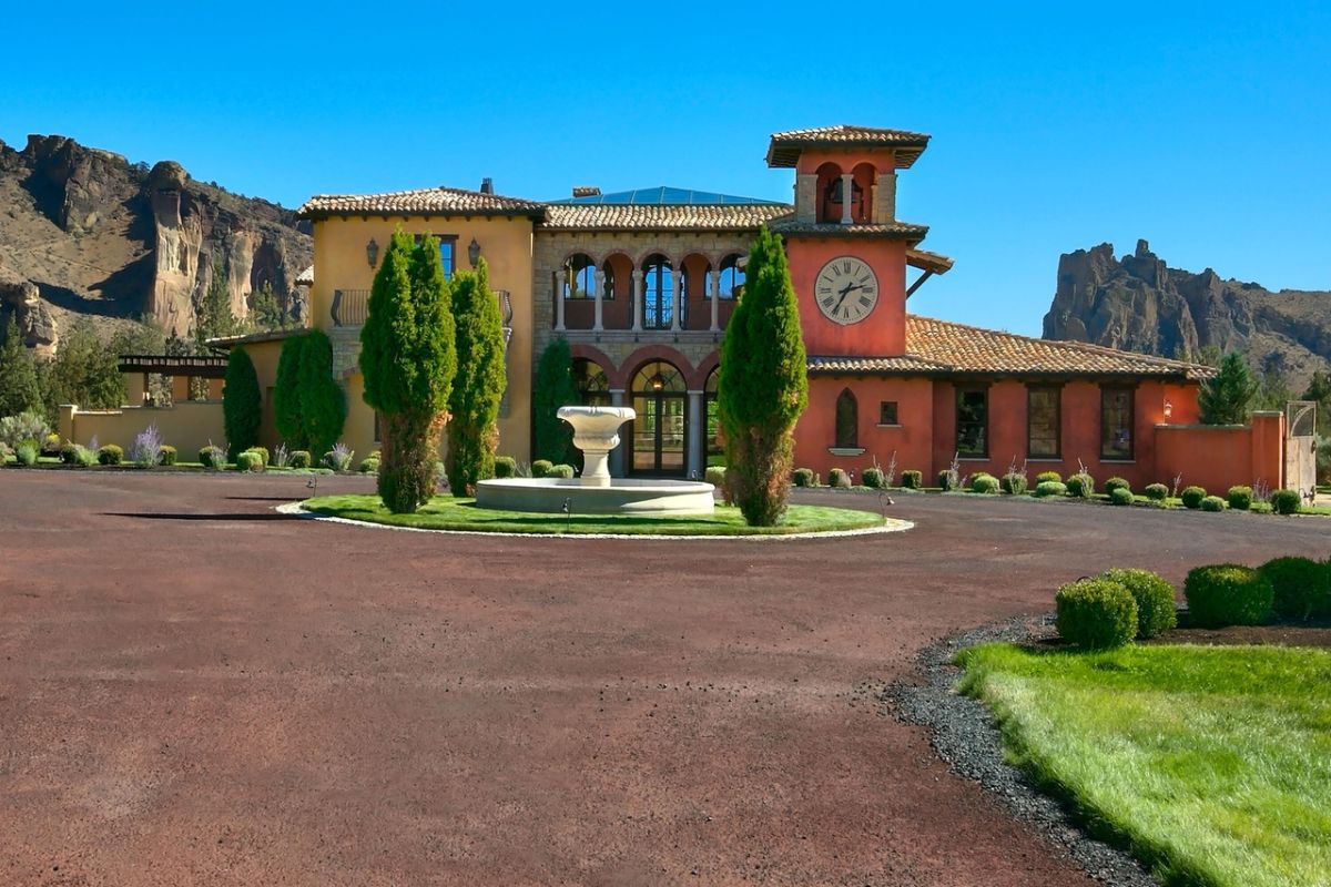 The house is a landscape with trees and a large analog clock on the wall.