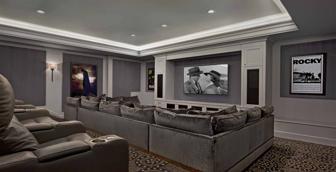 Media room with leather recliners and an oversized sofa filled with plenty of pillows.