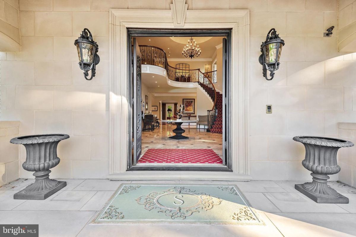 The entrance features large double doors that showcase the curve staircase.