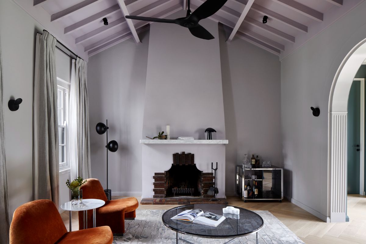 The living room features a fireplace and ceilings with exposed beams.