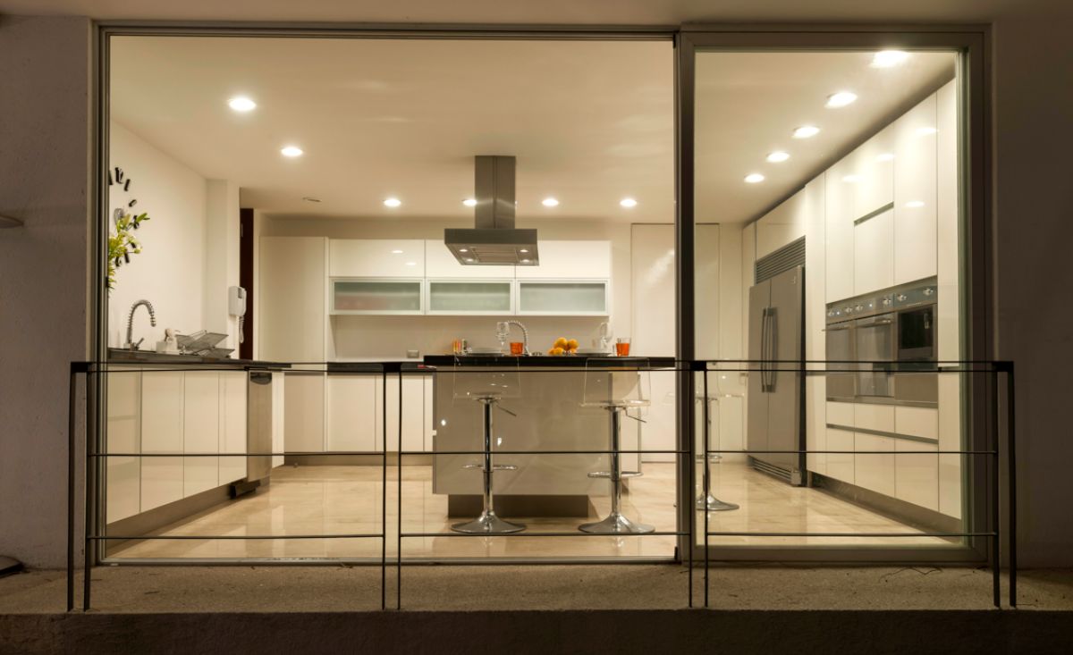 As seen through the large glass window, the kitchen is located on the ground floor.