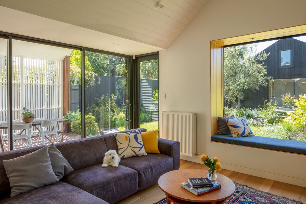 The living room features a sofa and round coffee table, giving the room a cozy feel.