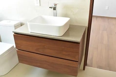 This photograph captures a section of the bathroom, specifically highlighting its single basin sink.