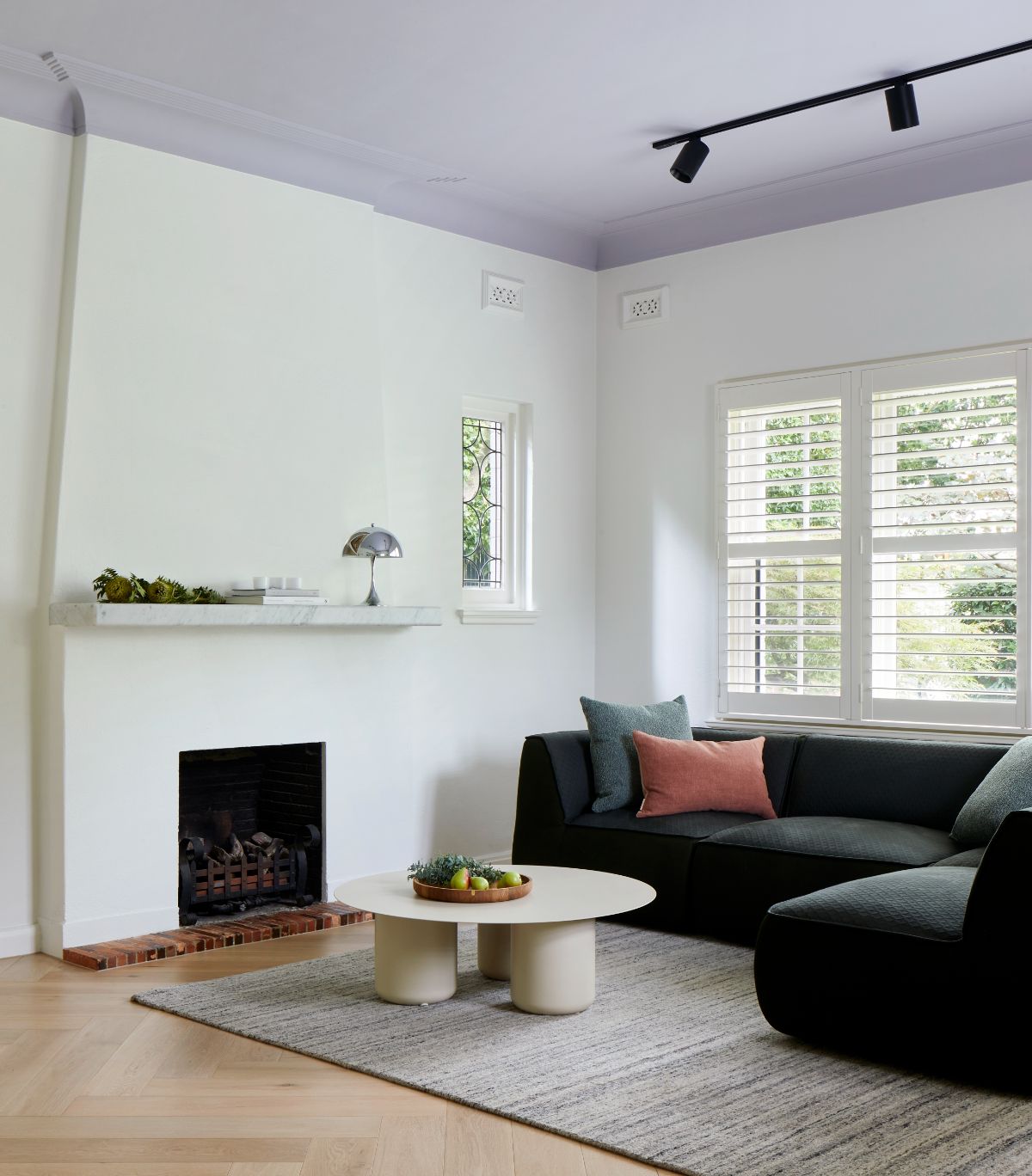 The sitting room features a modular so, and the fireplace gives the room a cozy feel.