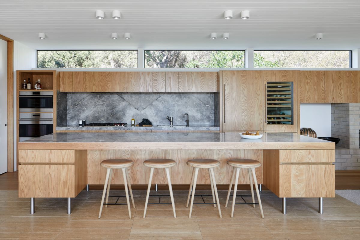 The kitchen features a bi-level kitchen island with a marble countertop.