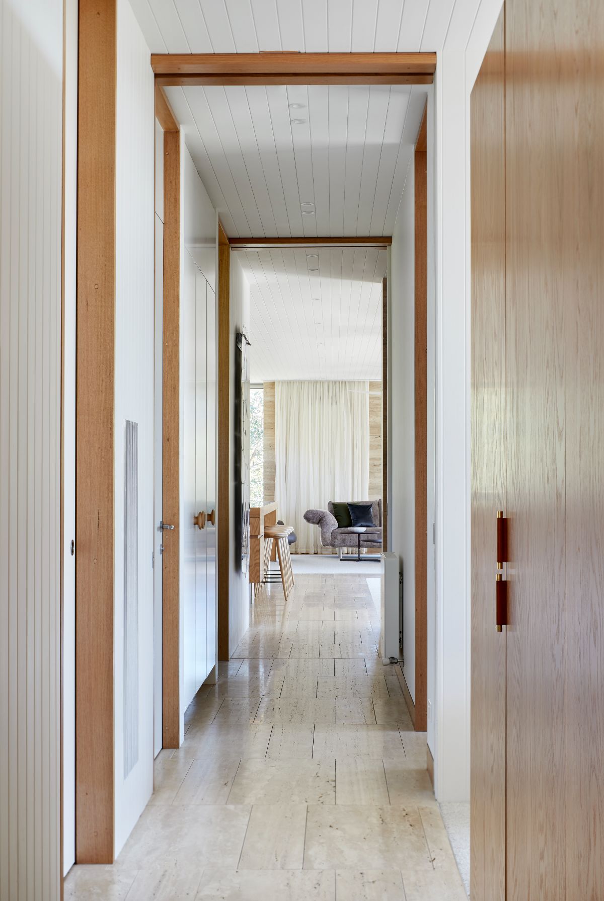 From the living area, the hallway leads to the bedrooms.