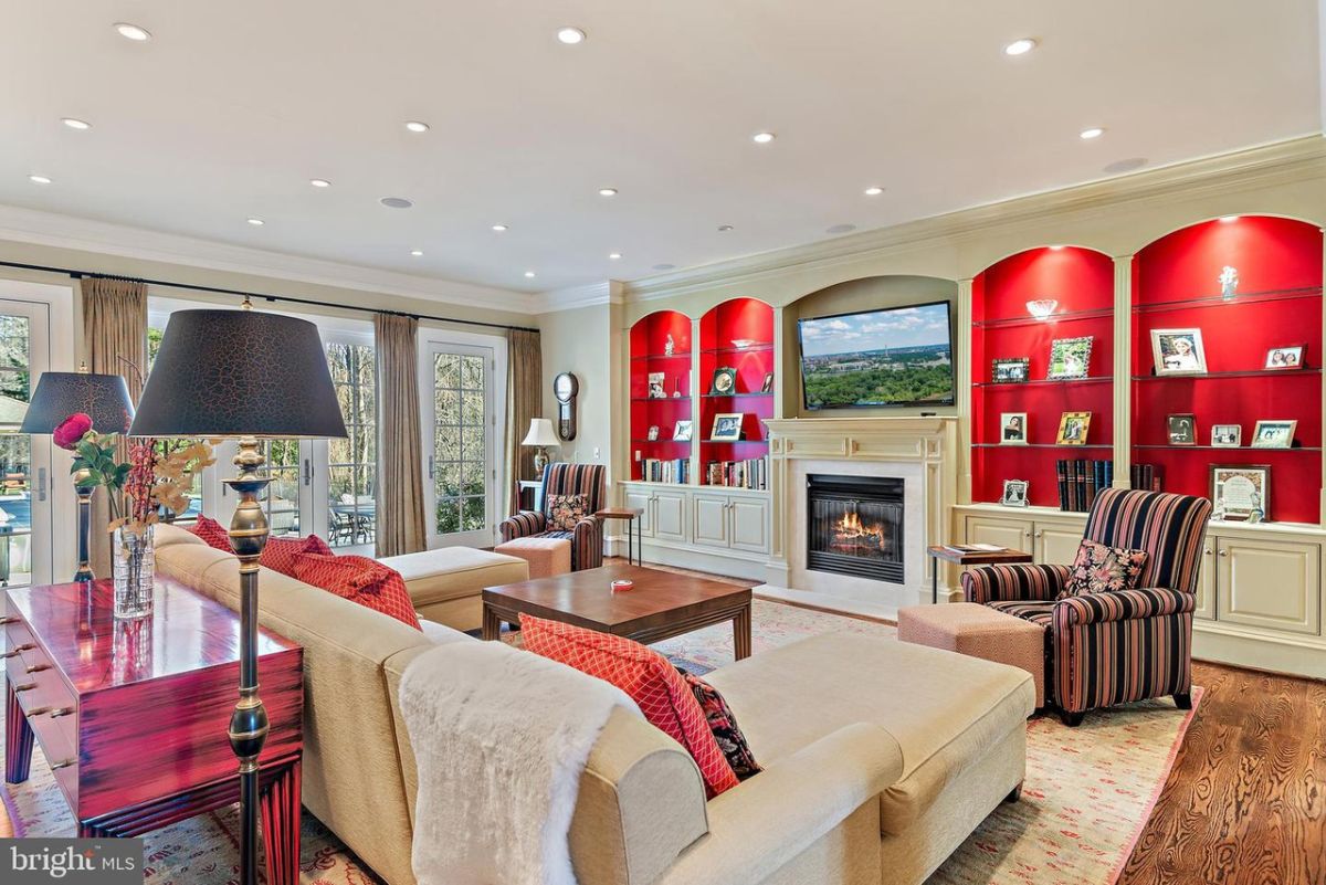 The living room features a carpet, sofas, and a fireplace to warm the area.