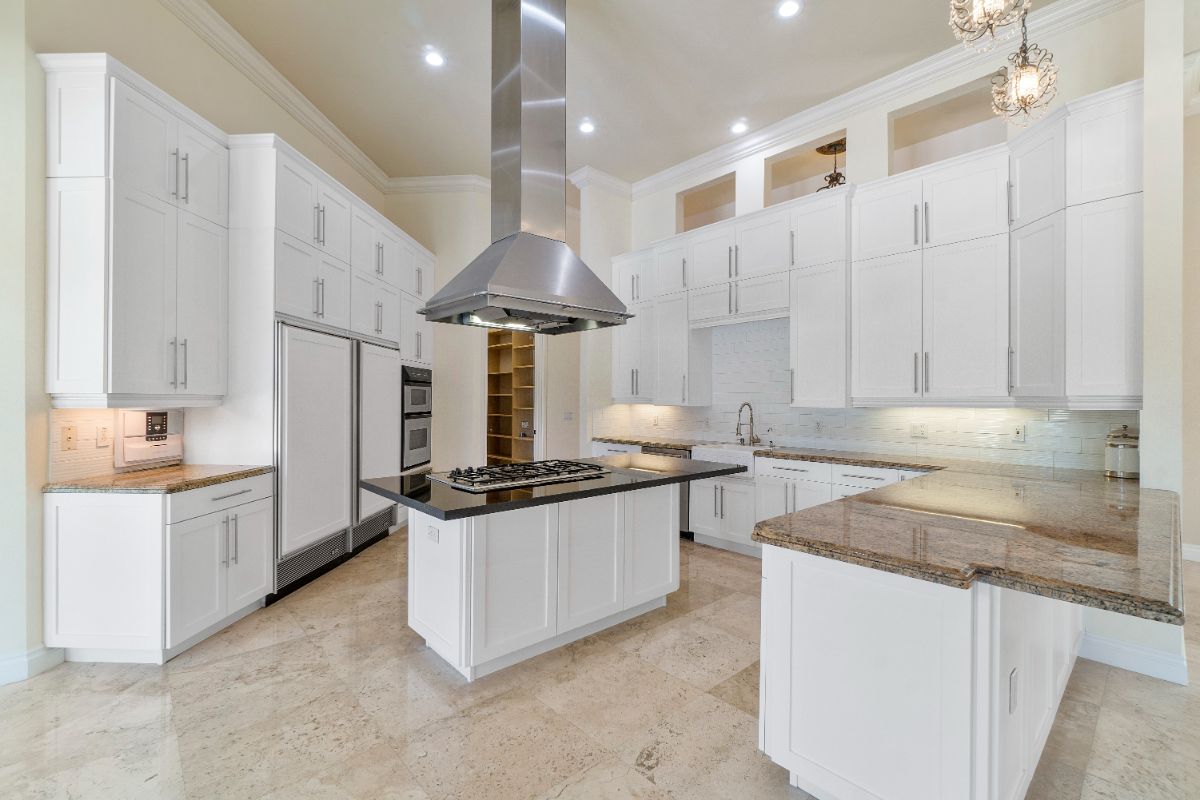 The kitchen features a kitchen peninsula and a kitchen island with a granite countertop.