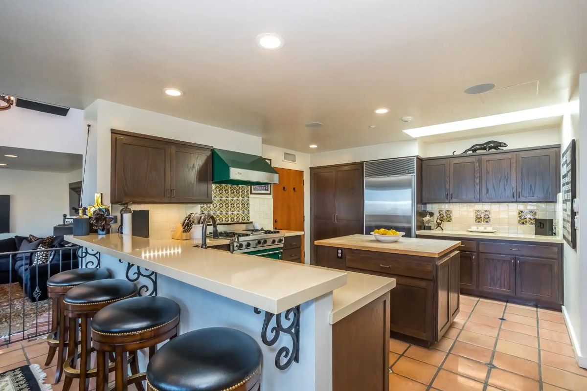 The kitchen area features a bi-level kitchen peninsula and a kitchen island.