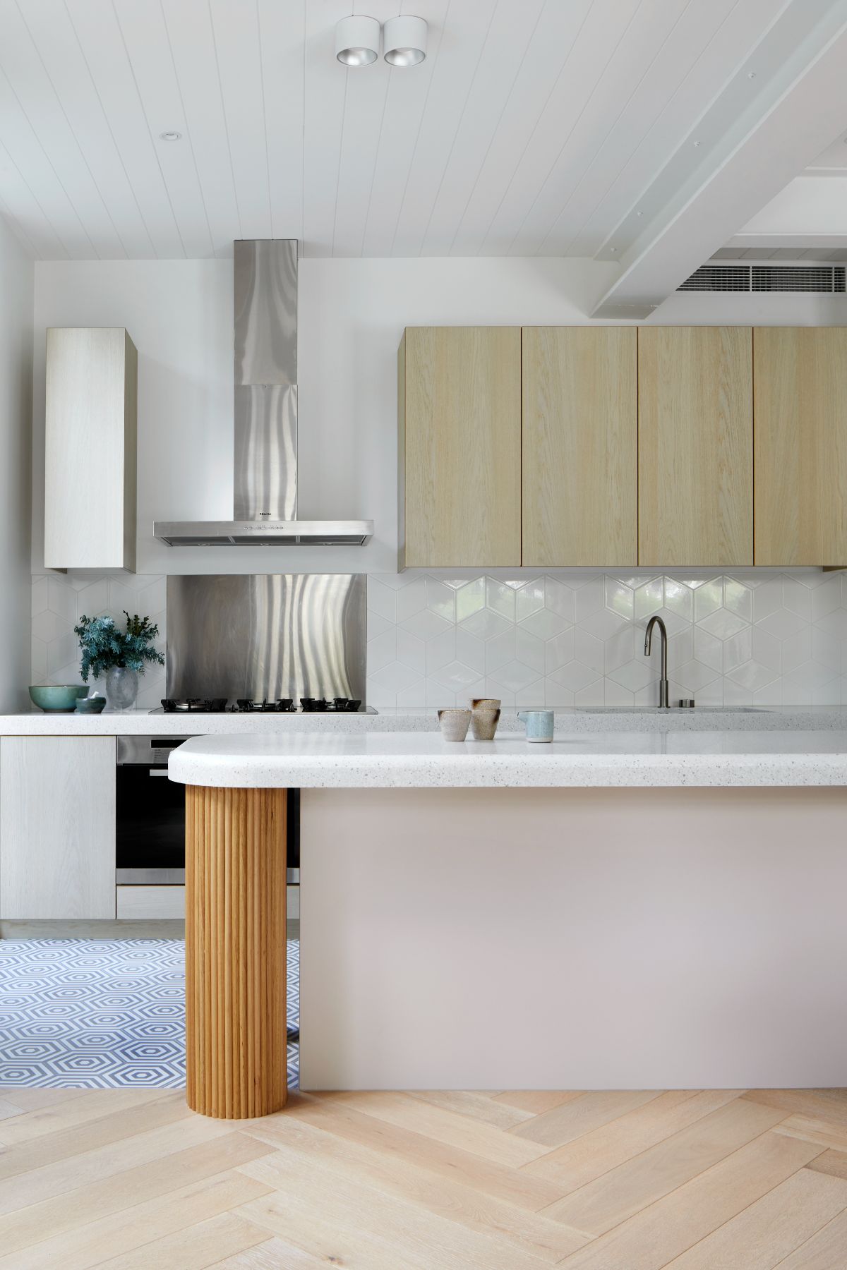 The kitchen features a built-in kitchen island with a tile countertop.