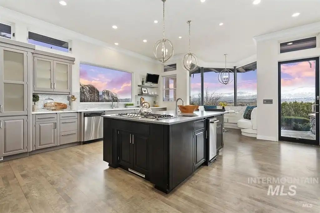 The kitchen features a square bi-level kitchen island and window seats to showcase the outside views.