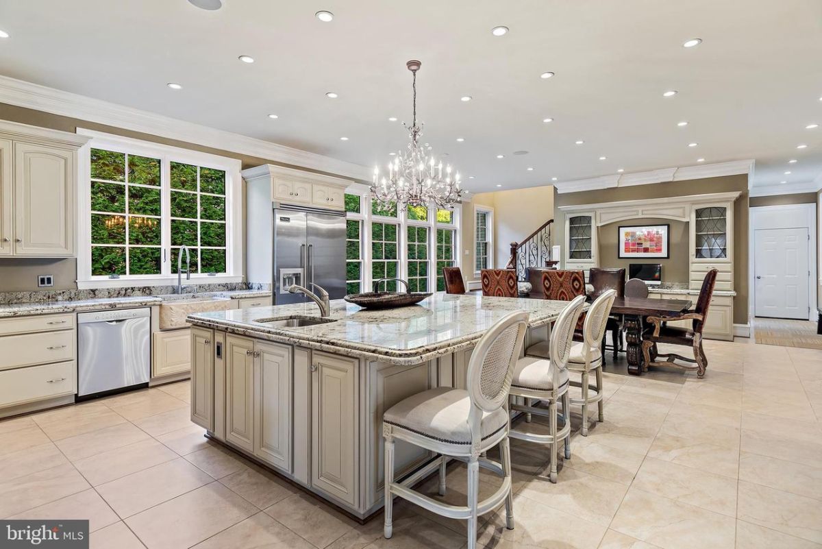 The house has a large kitchen room with a kitchen island and a dinette.