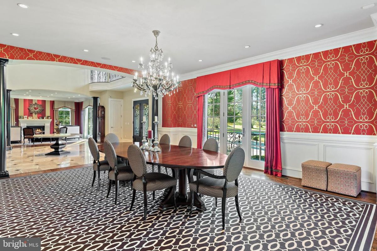 The dining area features an oval wooden table, and the wall decor gives the house a luxurious look.