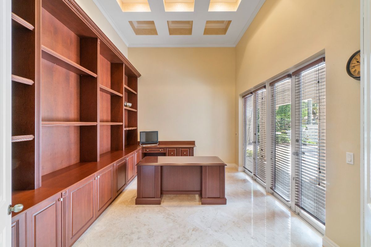 The study room features a wooden table and glass windows that overlook the outside view.