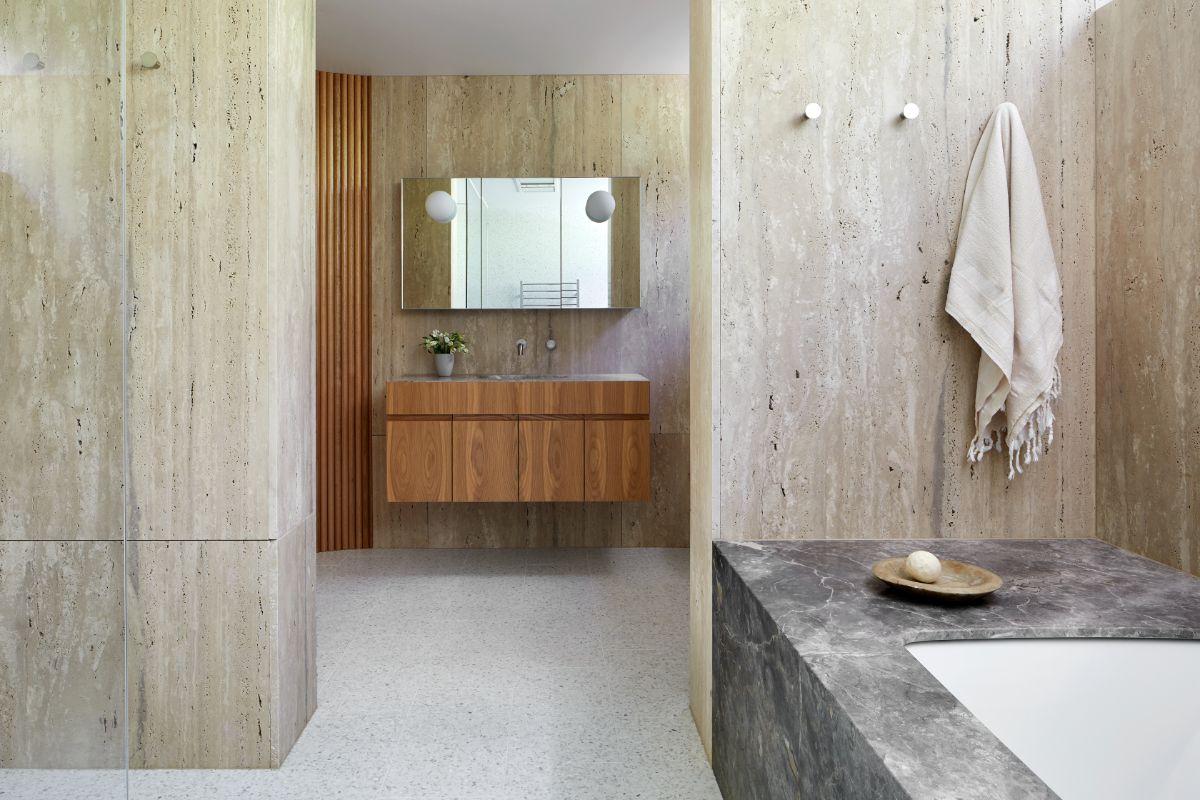 The bathroom features a floating vanity and a built-in bathtub.