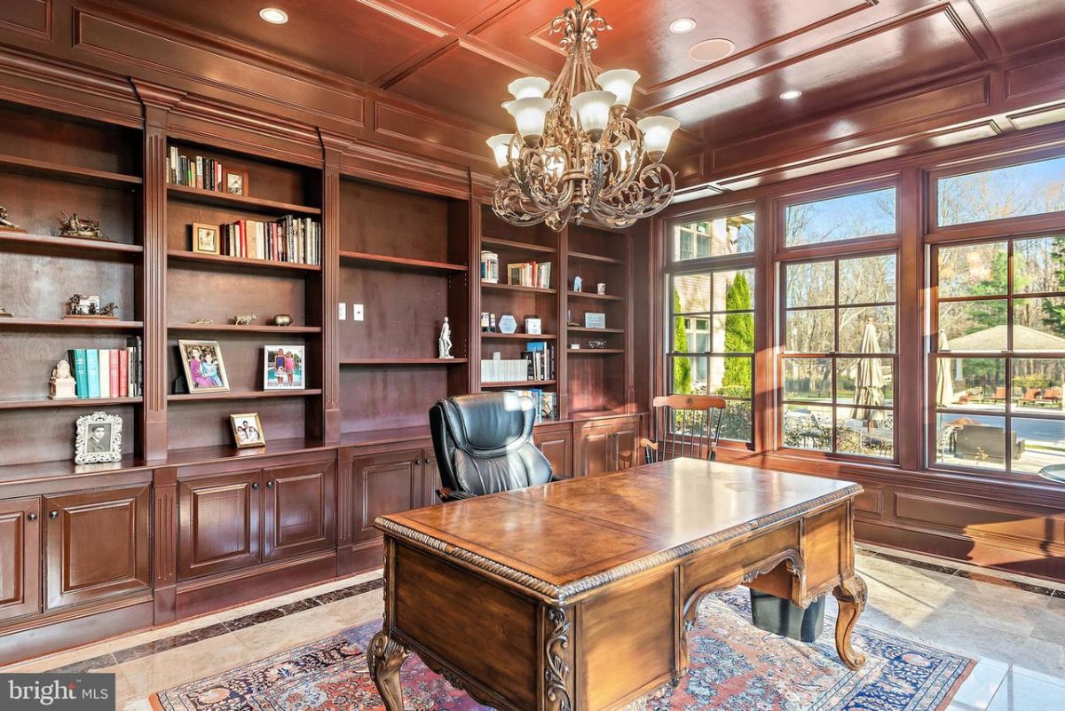 The study with a wooden ceiling and table gives the room a classic look.