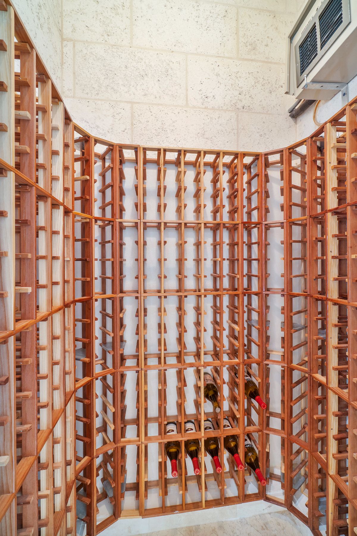 The house features a wine cellar, and the wooden wine racks give the room a rustic feel.