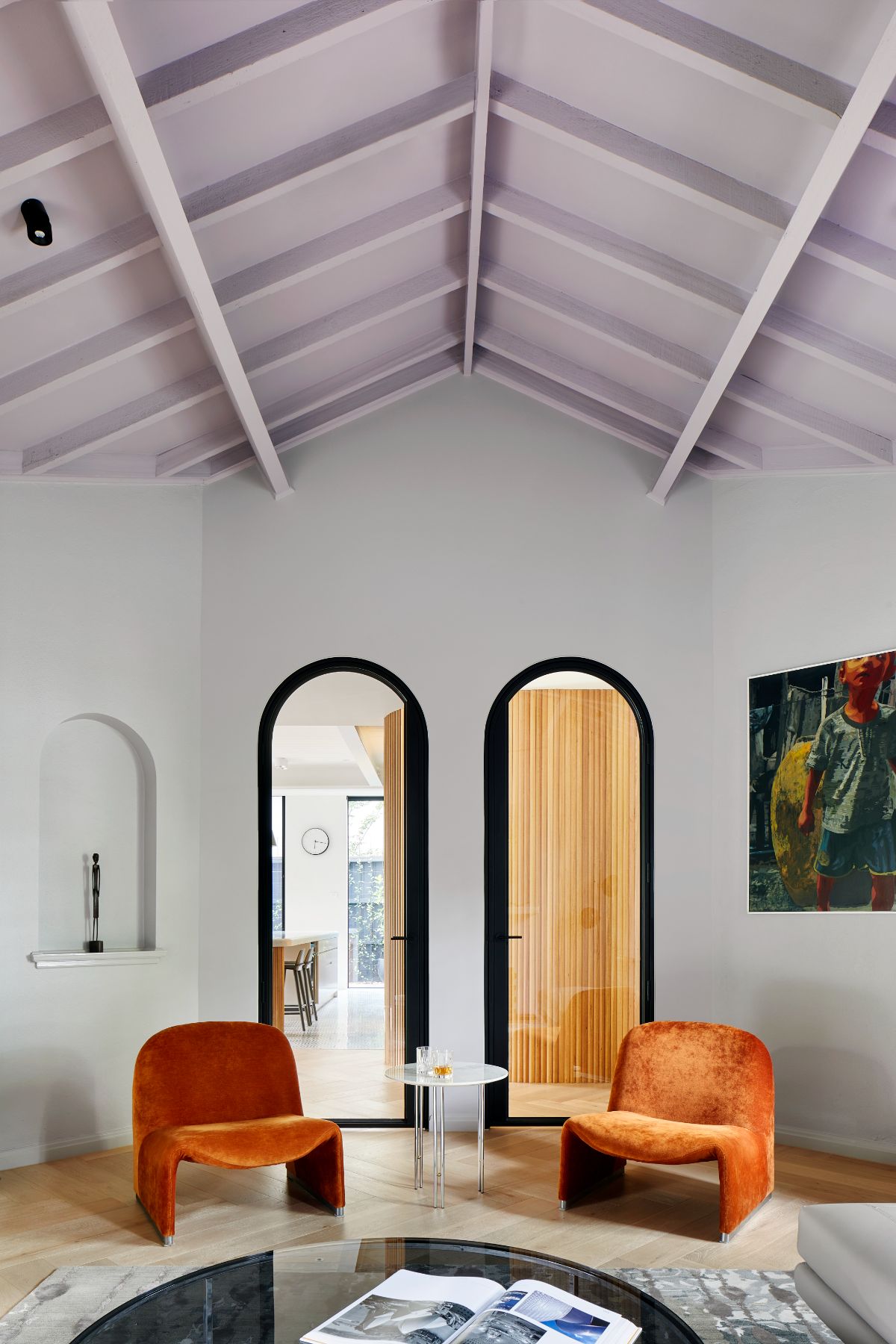 Modern inspired dining room with pops of colour from jewel coloured chairs to play off the art deco heritage of the home.