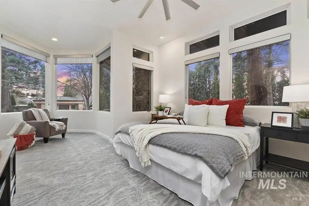 The bedroom features a wall-to-wall carpeting giving the room a cozy feel.