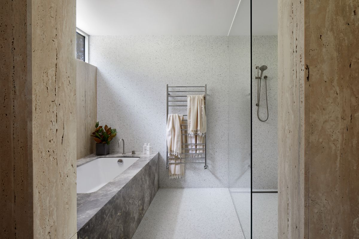 The bathroom features a shower enclosed with glass.