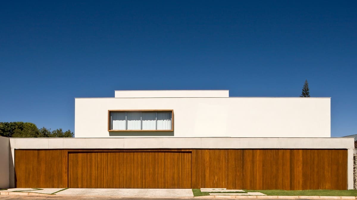 Home's facade showcasing its contemporary volumes with timber slat cladding.