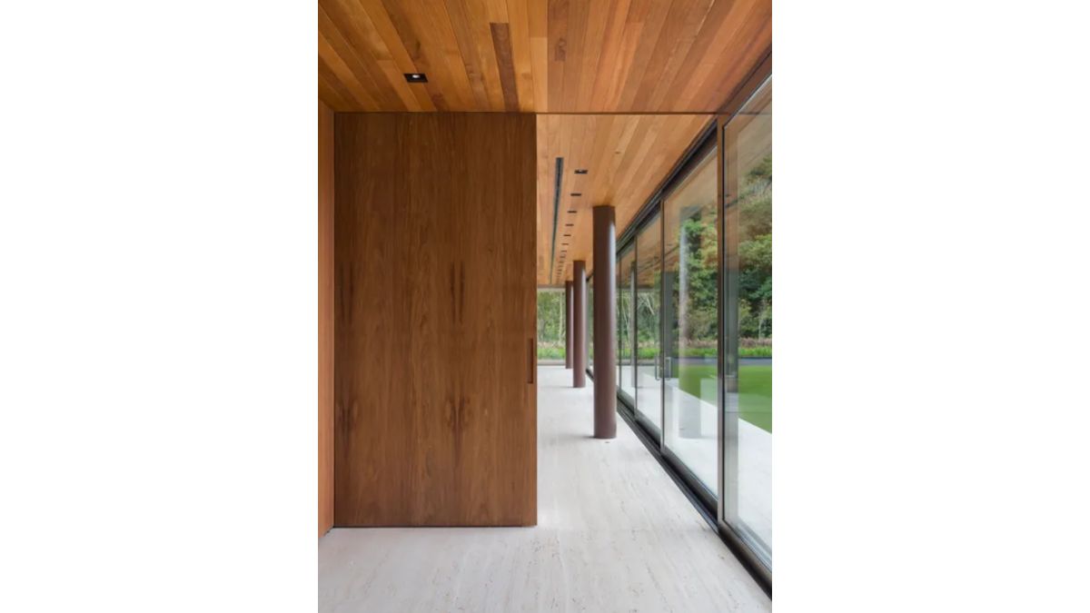 The glass-walled passageway offers views of the outside.