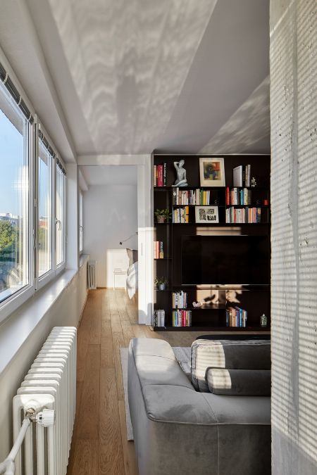 This is an interior shot taken from the side of the wall near wide windows, offering a breathtaking view of the outdoors from a high vantage point.