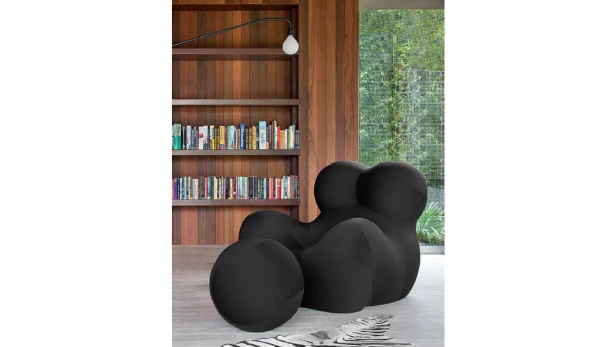 It's pleasant to study and unwind in the home's miniature library while sitting in a comfortable black soft chair.