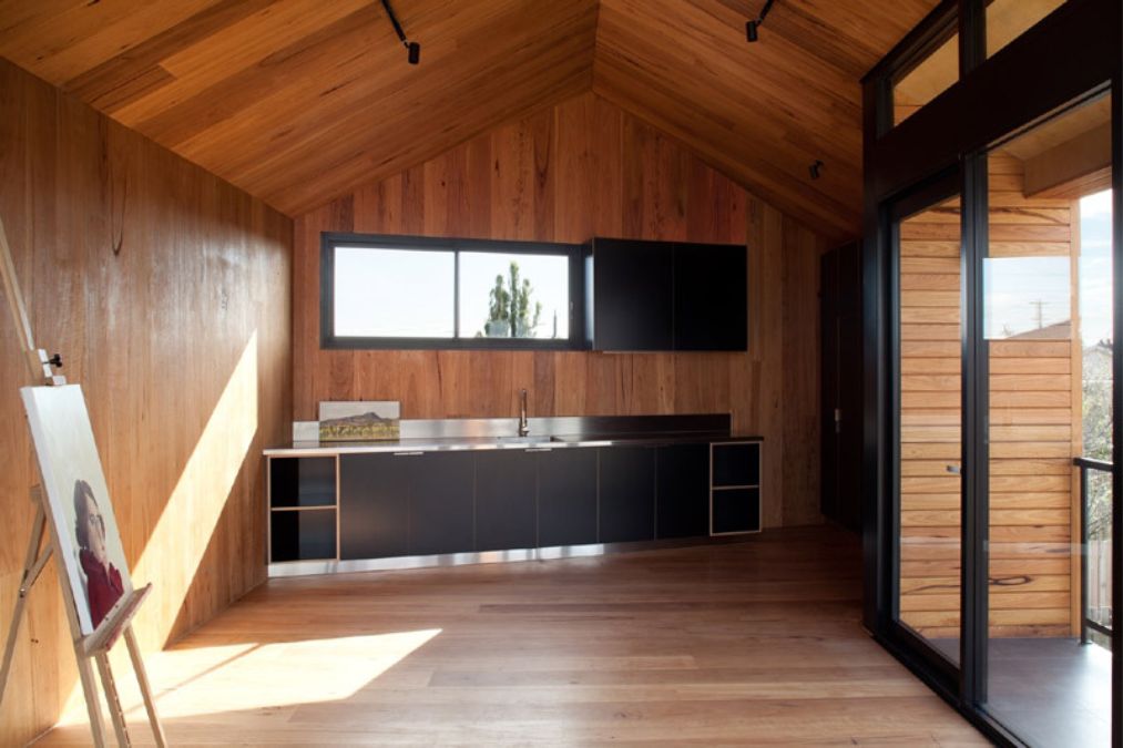 A photograph featuring the kitchen area and the sliding glass door leading to the outdoor deck.