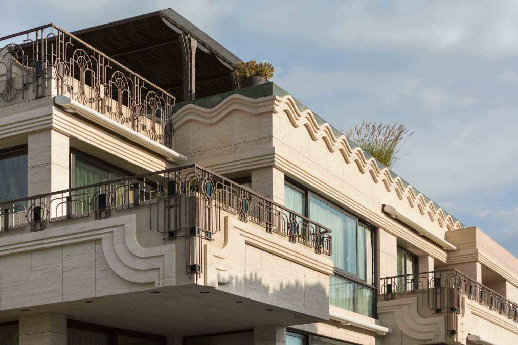 This high angle shot captures the unique design elements of the house, including the wavy patterns and intricate stone carvings that give the house its distinct identity.