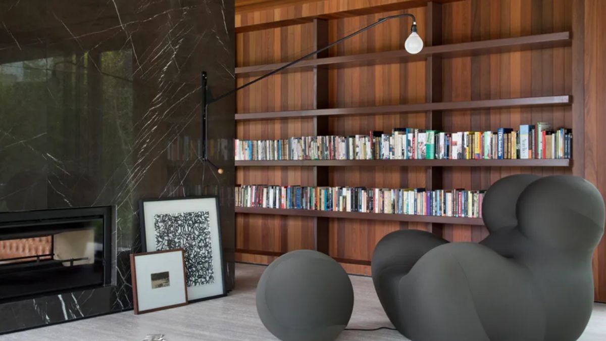 The small library is perfectly positioned to face the fireplace.