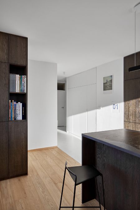 This is an interior shot taken from the kitchen area, showcasing the seamless connection between the kitchen and other rooms. 