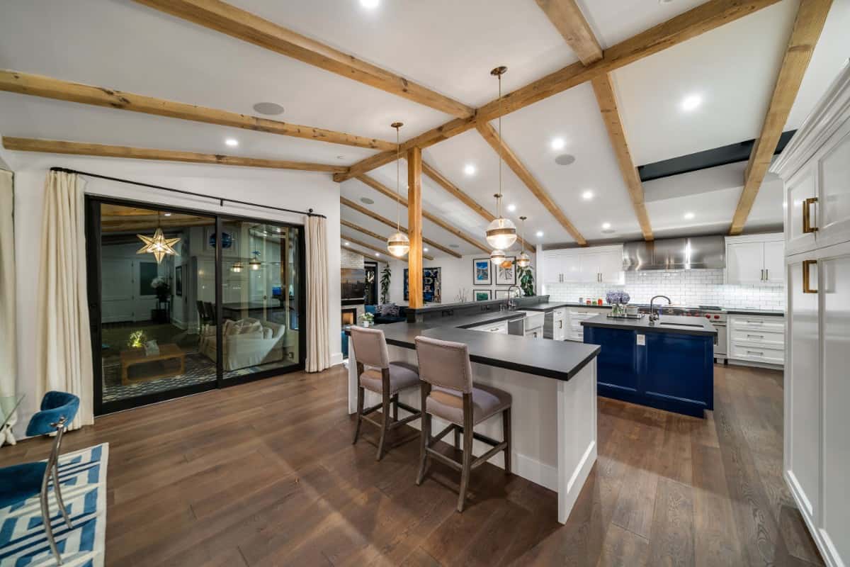 Chef’s kitchen with custom cabinetry, a center island, and an eating bar.