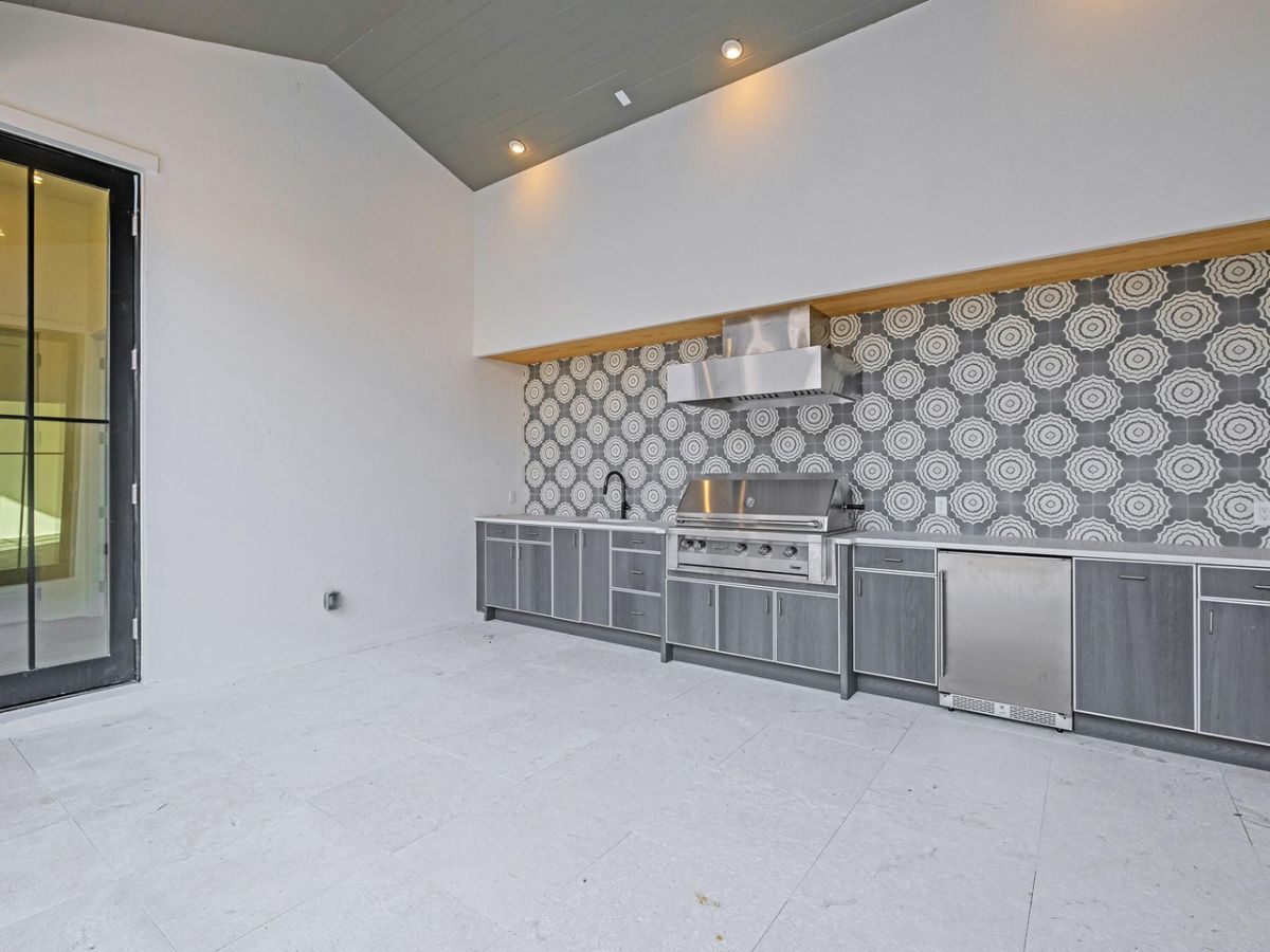 The kitchen features tile flooring that goes well with the white paint.