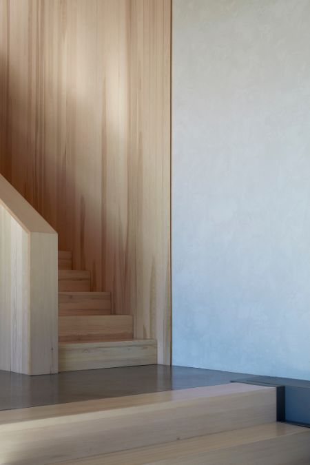 A close-up shot highlighting a wooden staircase ascending upwards.