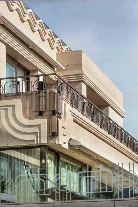 This detailed shot captures the corner section of the deck, highlighting the intricate stone carvings and wavy design that are mounted on certain sections of the wall.